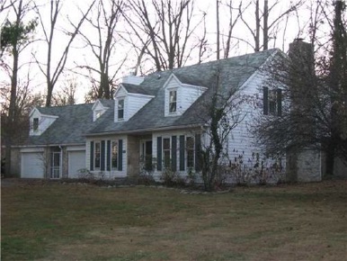 Center hall traditional: Living rm right, dining rm left, kitchen breakfast back left, beamed ceiling fireplaced family room back right.
Four beds & two bath up. Bonus rm above extra garage. Wooded site surrounds patio to back. See seller financing