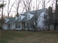 Center hall traditional: Living rm right, dining rm left, kitchen breakfast back left, beamed ceiling fireplaced family room back right.
Four beds & two bath up. Bonus rm above extra garage. Wooded site surrounds patio to back. See seller financing