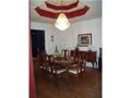 Dining Room: Hardwood floors, viewed from entry foyer, note ceiling design, invitational from common area of living room, yet private from kitchen service area.