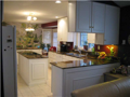 Kitchen: Stainless dbl bowl sink. White appliances compliment cabinets. Island cooktop. Granite c-tops. Vinyl tile flooring.