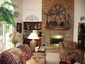 Masonry brick fireplace w seat hearth. Wet bar pass through. French doors exit to timber back deck. Two story ceiling.