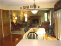 Kitchen / breakfast / family room area is all open for interactive visual. Easily access via glass slider to heavy timber decks and south lakeside views. Hardwood flooring, stained woodwork with 6-panel doors, real wood cabinets and SS appliances
