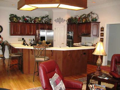 Cherry hardwood floors, stainless appliances, Corian c-tops with inlay, real wood cabinets, pantry, indirect lighting, & nice woodwork from casing to crowns.