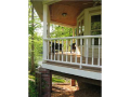 Porch bead ceiling, double hung windows, colonial balusters, a mix of stained and painted, brick columns, all define and compliment the perfect mix of Victorian, craftsman, and American traditional for casual or formal lakeside living