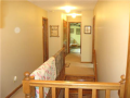 Hardwood stair treads and risers to both upper bedroom level and to lower level walkout. The upper bed hall is well lighted. The master bed is lakeside and to the opposite end of three other auxiliary bedrooms. All beds have walk-in closets