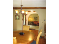 Traditional design with sizeable rooms define foyer, formal dining, and parlor off entry area. Hardwood flooring, crown moldings, arched openings, and sold mahogany (pewter caming in glass) entry door reflect a quality while creating function