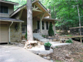 Exterior Front: Landscaped to include front deck, fieldstone retaining walls, entry concrete walk, sandstone walk path, covered entry timber porch. Aesthetically pleasing for plants and people.